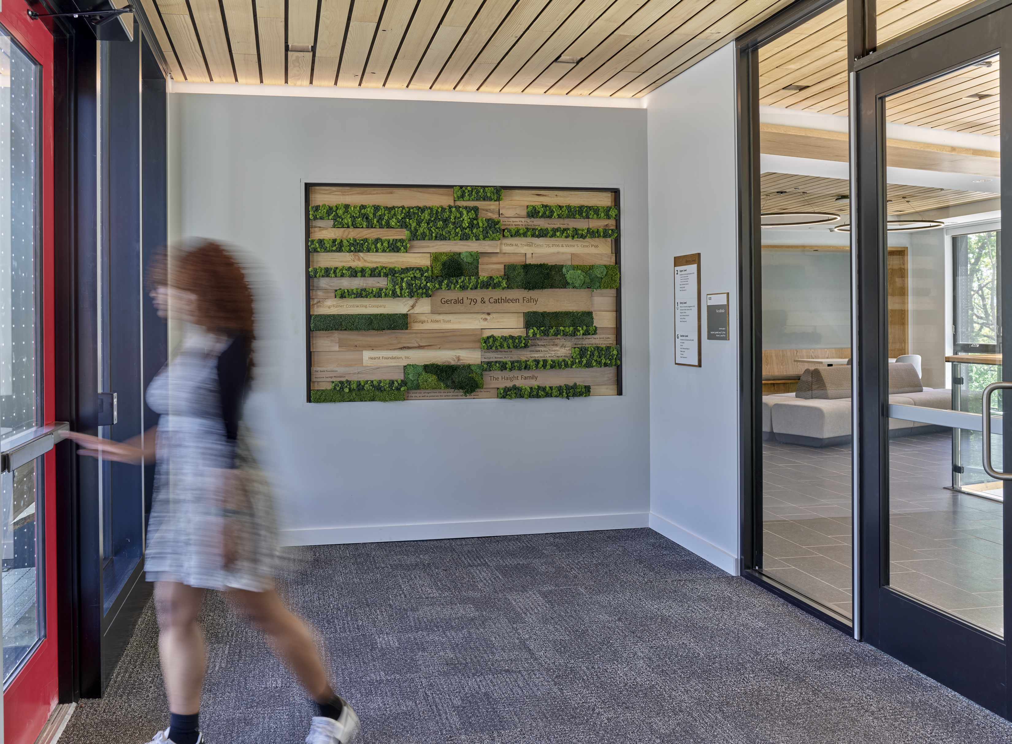 Interface SR999 carpet tile in entryway of college building with living wall